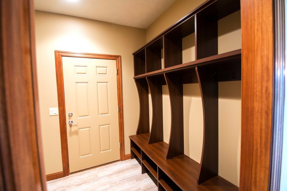 This is an example of a traditional mudroom in Other with beige walls.