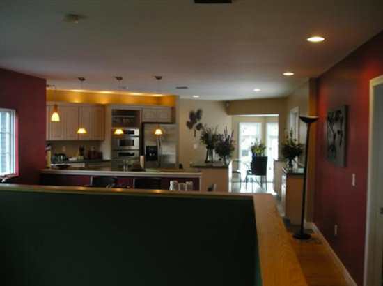 Open concept kitchen - mid-sized galley open concept kitchen idea in Burlington with raised-panel cabinets, light wood cabinets and stainless steel appliances