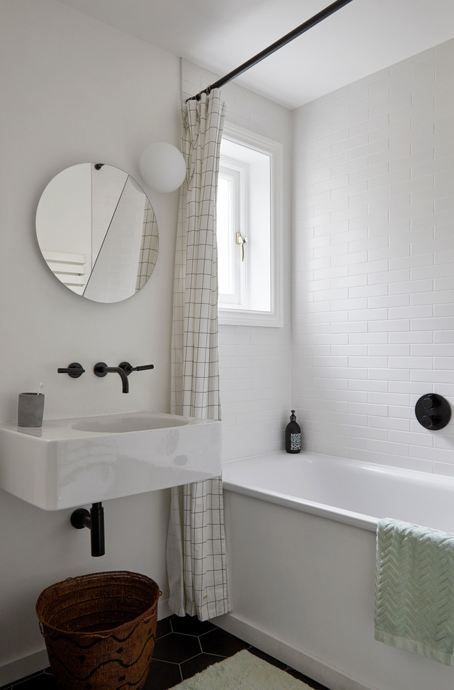 Small contemporary kids bathroom in London with a drop-in tub, white tile, ceramic tile, white walls, ceramic floors, a wall-mount sink, marble benchtops, black floor, white benchtops and a curbless shower.
