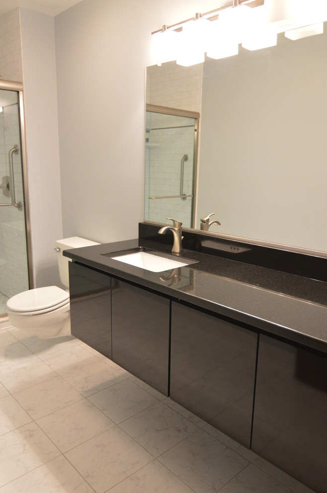 Design ideas for a mid-sized modern 3/4 bathroom in DC Metro with flat-panel cabinets and black cabinets.