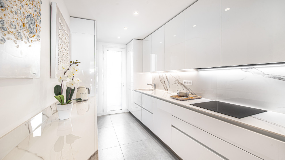 Design ideas for a mid-sized contemporary galley separate kitchen in Nice with an integrated sink, beaded inset cabinets, white cabinets, solid surface benchtops, white splashback, panelled appliances, ceramic floors, grey floor and white benchtop.