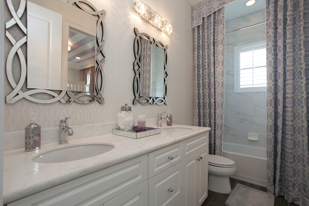 Mid-sized transitional 3/4 white tile and marble tile porcelain tile and gray floor alcove bathtub photo in Miami with raised-panel cabinets, white cabinets, a two-piece toilet, multicolored walls, an undermount sink and quartzite countertops