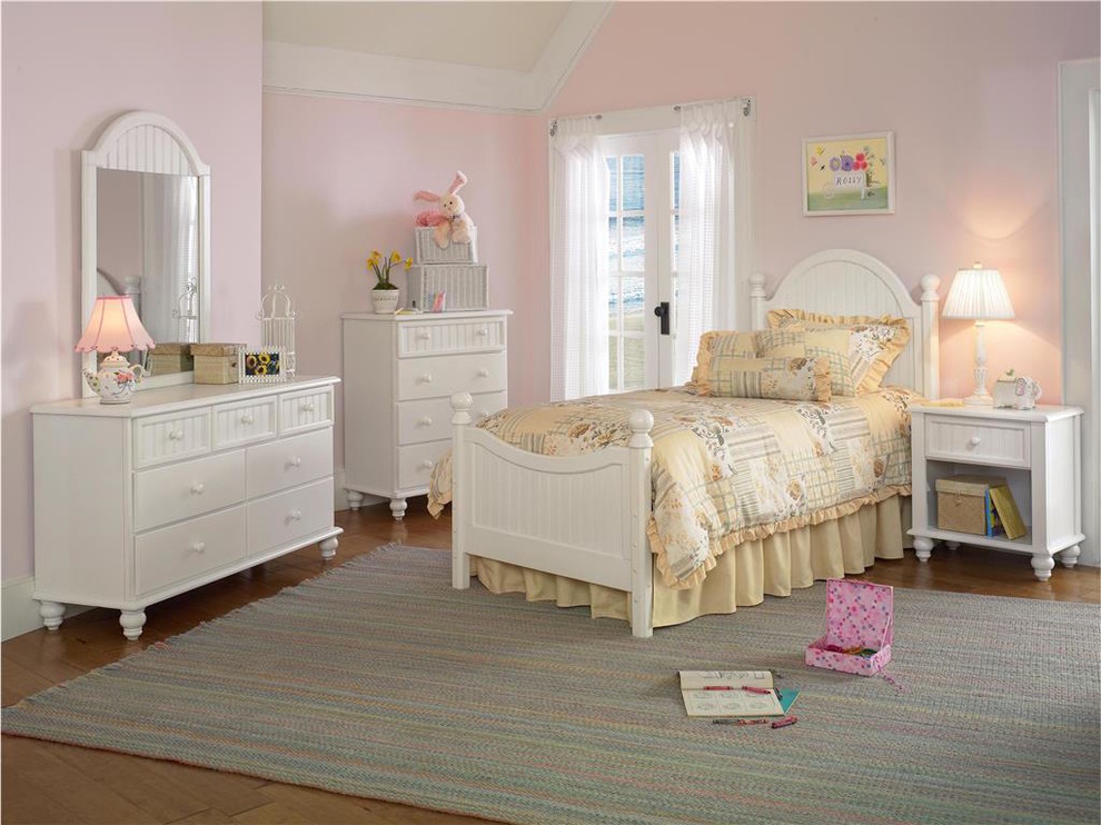 This is an example of a mid-sized bedroom in New York with pink walls and medium hardwood floors.