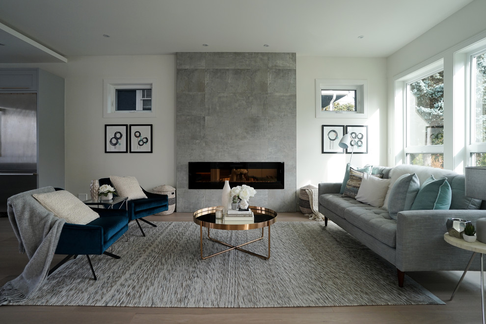 Design ideas for a mid-sized contemporary formal open concept living room in Vancouver with white walls, light hardwood floors, a tile fireplace surround, beige floor and a ribbon fireplace.