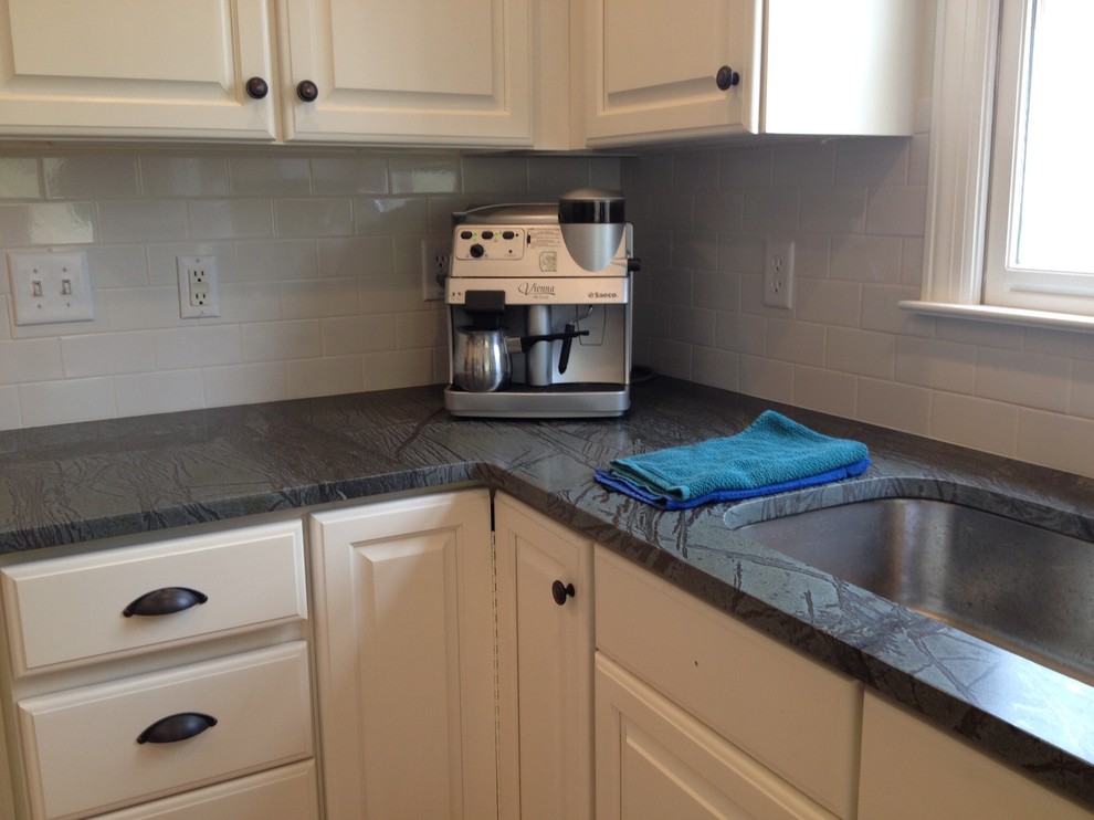 Inspiration for a light wood floor kitchen remodel with soapstone countertops, white backsplash and ceramic backsplash
