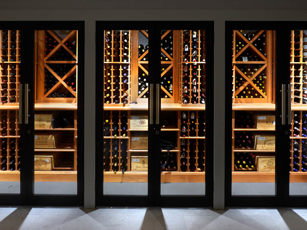 This is an example of a traditional wine cellar in New York with porcelain floors and diamond bins.