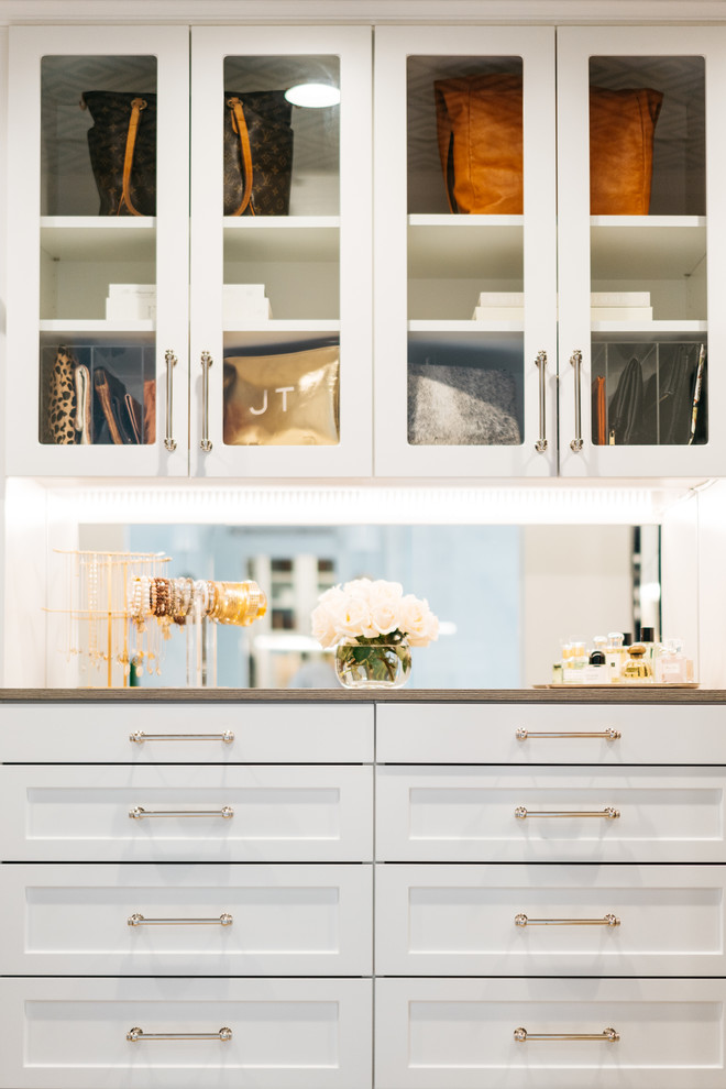 Design ideas for a mid-sized transitional gender-neutral walk-in wardrobe in San Francisco with shaker cabinets, white cabinets, medium hardwood floors, brown floor and wallpaper.