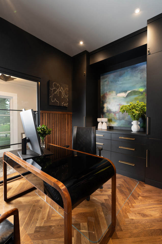 Mid-sized trendy freestanding desk medium tone wood floor and brown floor home office photo in Other with black walls