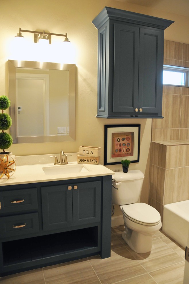 Photo of a mid-sized transitional master bathroom in Oklahoma City with shaker cabinets, white cabinets, a drop-in tub, an alcove shower, a two-piece toilet, gray tile, porcelain tile, beige walls, porcelain floors, an undermount sink, granite benchtops, beige floor and a sliding shower screen.