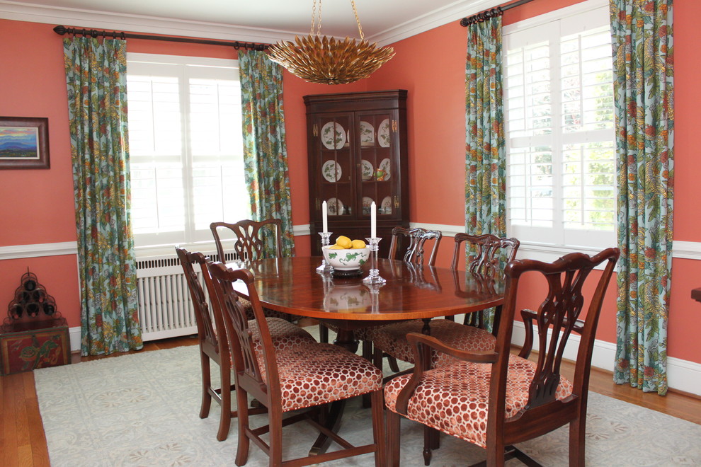 Photo of a mid-sized contemporary separate dining room in Richmond with orange walls, medium hardwood floors and no fireplace.