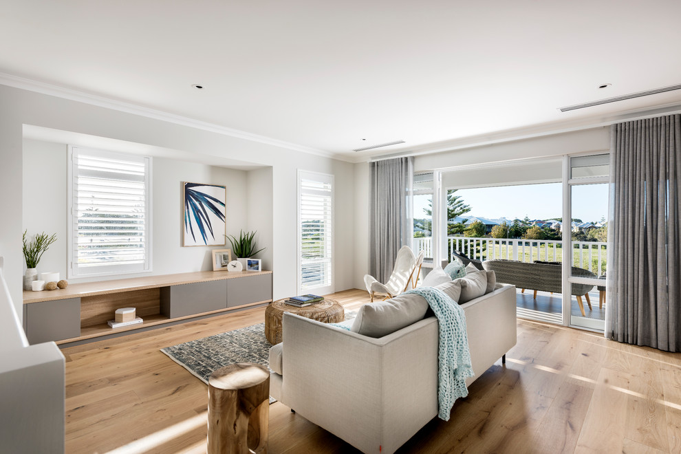 Design ideas for a beach style living room in Perth with grey walls, light hardwood floors, no tv and beige floor.