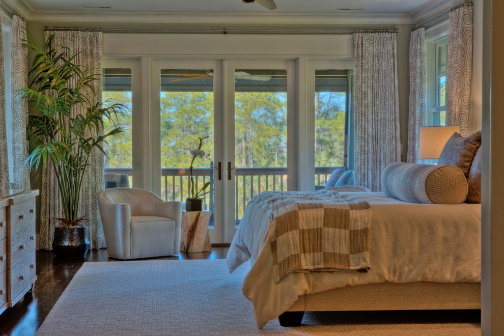 Mid-sized tropical guest bedroom in Charleston with beige walls, dark hardwood floors and no fireplace.