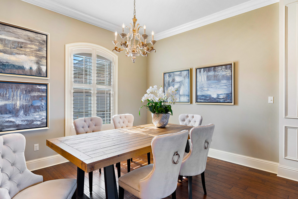 Large transitional dining room in New Orleans with beige walls, medium hardwood floors and brown floor.