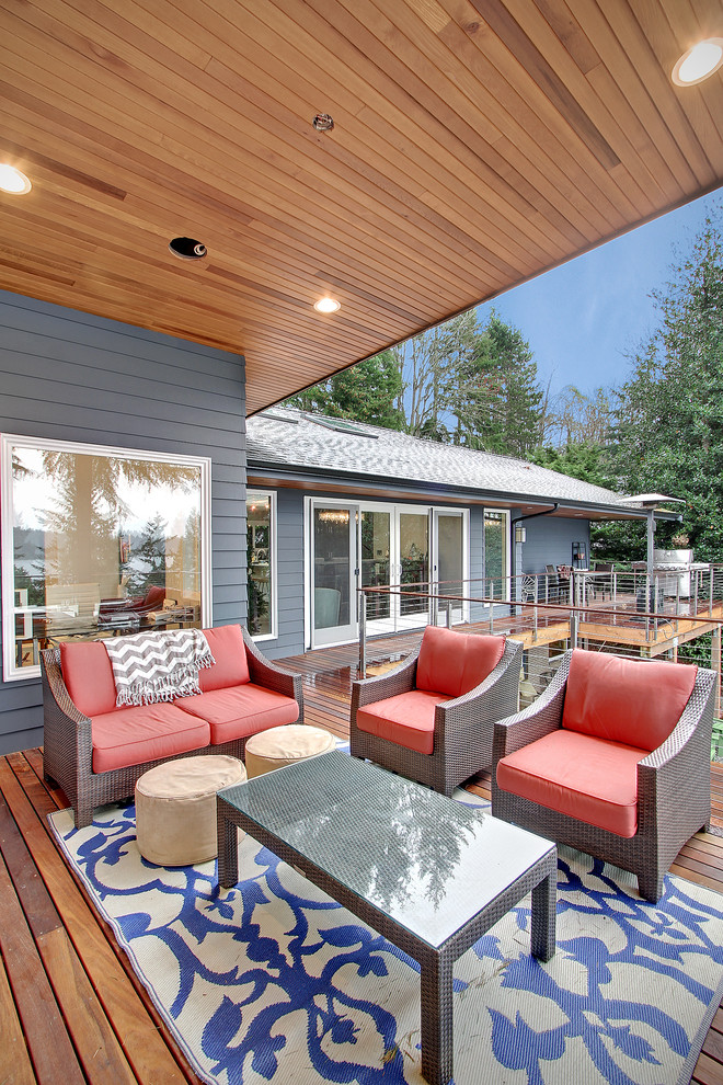 Photo of a traditional deck in Seattle with a roof extension.