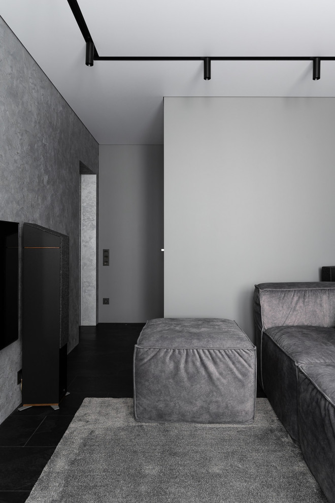 Imagen de cine en casa cerrado contemporáneo de tamaño medio con paredes grises, suelo vinílico, pared multimedia y suelo negro