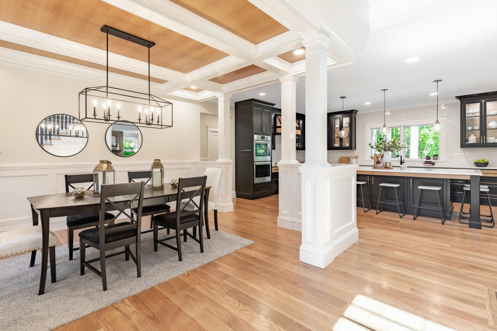 Large eclectic open plan dining in Boston with beige walls, medium hardwood floors, brown floor, coffered and decorative wall panelling.