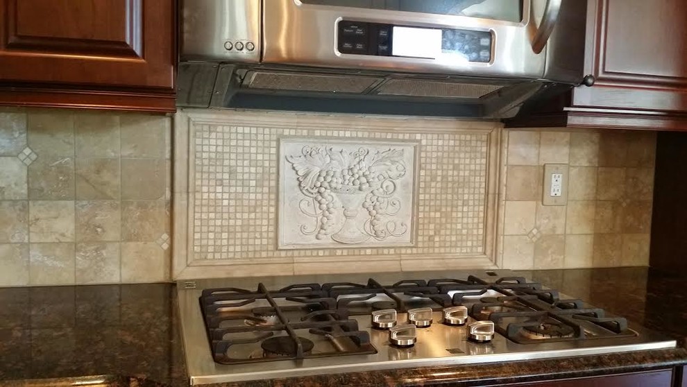 Kitchen - large traditional kitchen idea in Baltimore with raised-panel cabinets, dark wood cabinets, granite countertops, beige backsplash, stone tile backsplash and stainless steel appliances