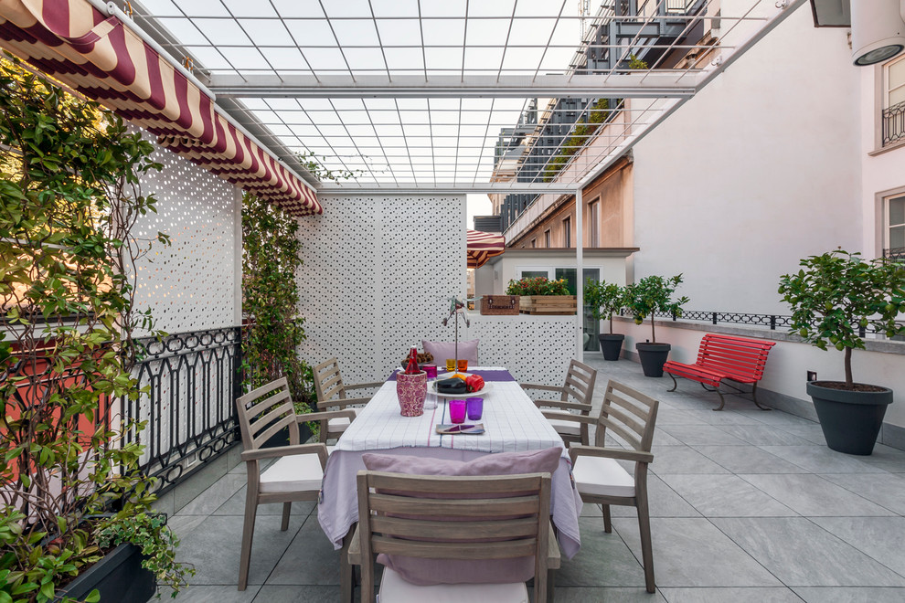 Photo of a large contemporary rooftop and rooftop deck in Milan with a pergola.