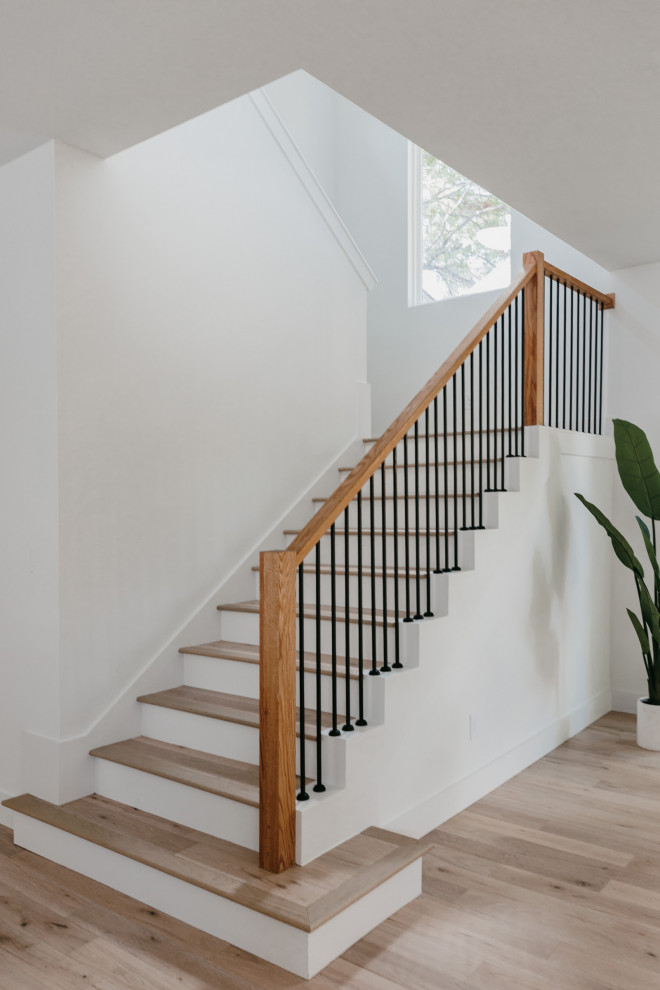 Inspiration for an expansive contemporary wood u-shaped metal railing staircase in Dallas with wood risers.