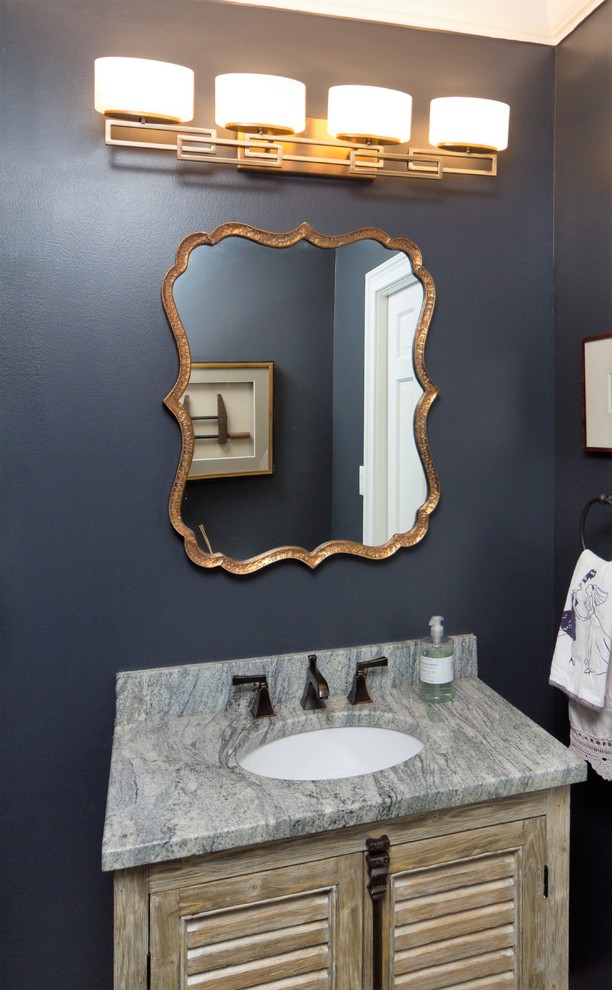 Design ideas for a mid-sized transitional powder room in Atlanta with louvered cabinets, distressed cabinets, blue walls, an undermount sink and engineered quartz benchtops.