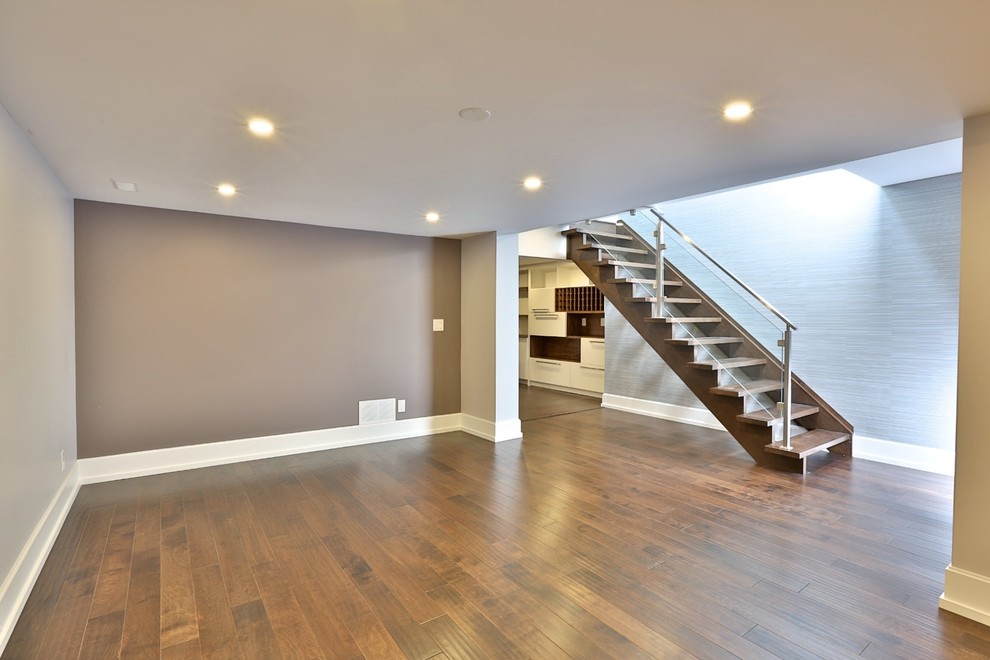 Large arts and crafts wood straight staircase in Toronto with open risers and mixed railing.