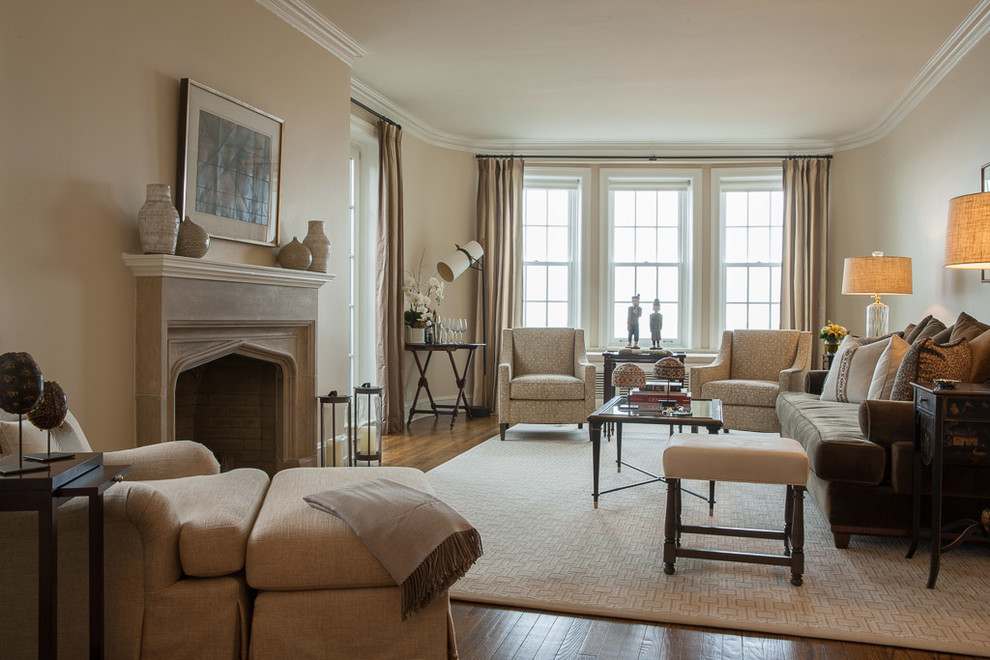 This is an example of a mid-sized traditional formal enclosed living room in Chicago with beige walls, medium hardwood floors, a standard fireplace, a stone fireplace surround, no tv and brown floor.