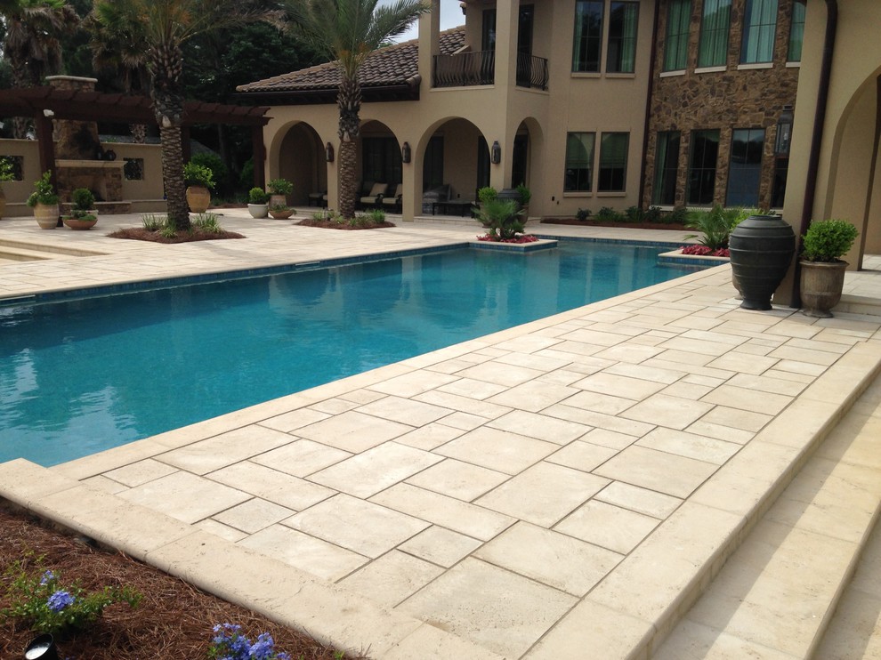 This is an example of a mid-sized mediterranean backyard patio in Miami with a fire feature, concrete pavers and a pergola.