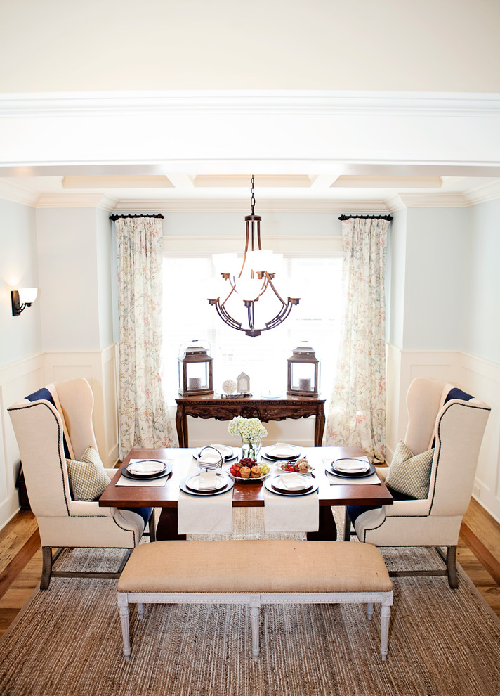 This is an example of a transitional dining room in Charlotte with blue walls and medium hardwood floors.