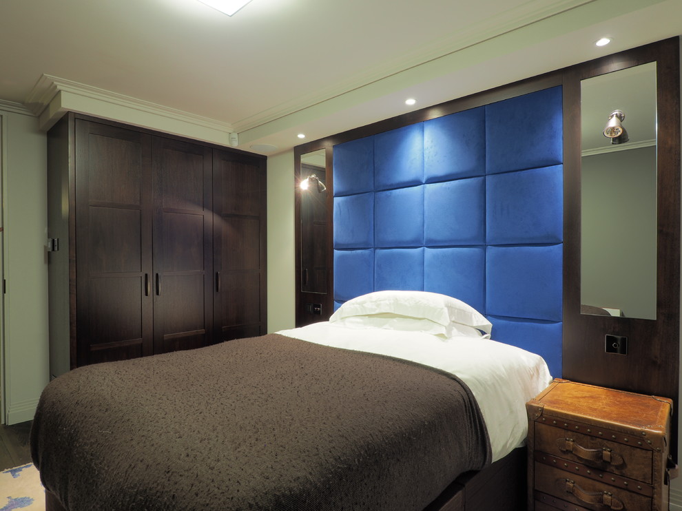 This is an example of a mid-sized contemporary guest bedroom in London with grey walls and medium hardwood floors.