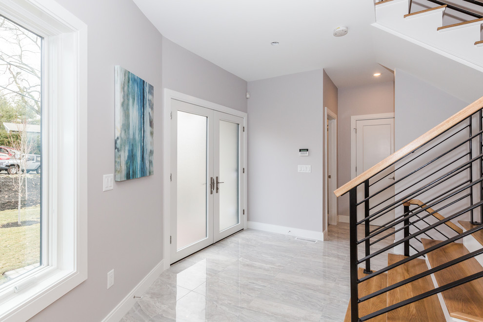 Small contemporary foyer in Boston with grey walls, porcelain floors, a double front door, a glass front door and grey floor.