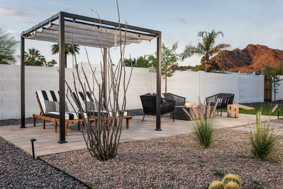 Design ideas for a mid-sized modern backyard garden in Phoenix with a fire feature and concrete pavers.