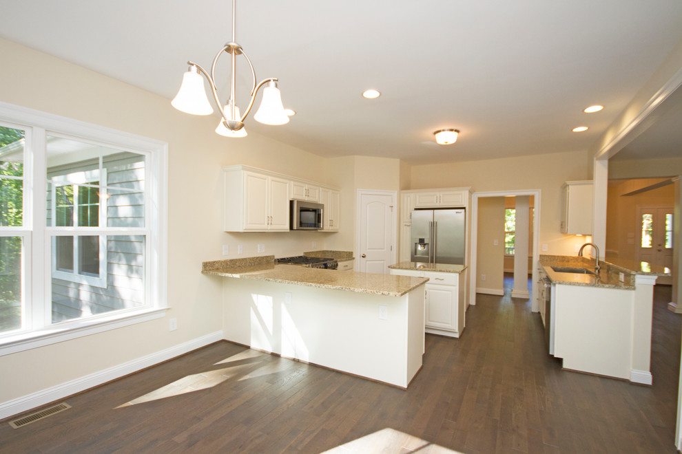 Eat-in kitchen - large transitional u-shaped dark wood floor eat-in kitchen idea in Richmond with a double-bowl sink, raised-panel cabinets, white cabinets, granite countertops, beige backsplash, stainless steel appliances and an island