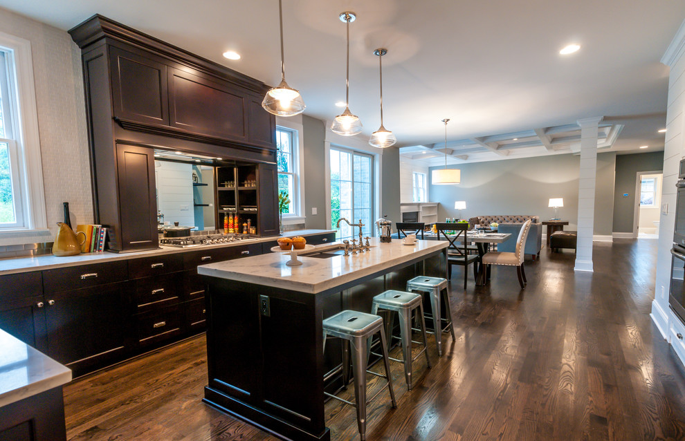 Example of a mid-sized transitional l-shaped dark wood floor eat-in kitchen design in Chicago with an undermount sink, recessed-panel cabinets, dark wood cabinets, quartzite countertops, white backsplash, ceramic backsplash, stainless steel appliances and an island