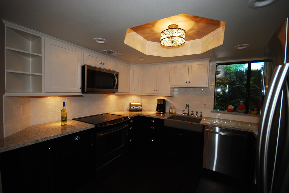 Eat-in kitchen - small transitional u-shaped porcelain tile eat-in kitchen idea with a farmhouse sink, shaker cabinets, white cabinets, quartz countertops, white backsplash, subway tile backsplash, stainless steel appliances and gray walls