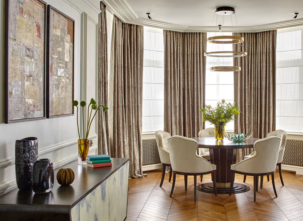 Inspiration for a transitional dining room in Moscow with white walls, medium hardwood floors and brown floor.
