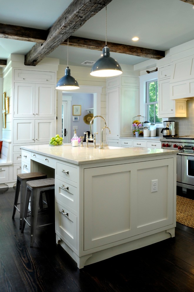 Design ideas for a traditional kitchen in New York with a farmhouse sink, white cabinets, glass tile splashback, stainless steel appliances, dark hardwood floors, with island, quartzite benchtops and grey splashback.