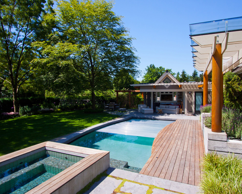 Example of a transitional backyard custom-shaped hot tub design in Vancouver