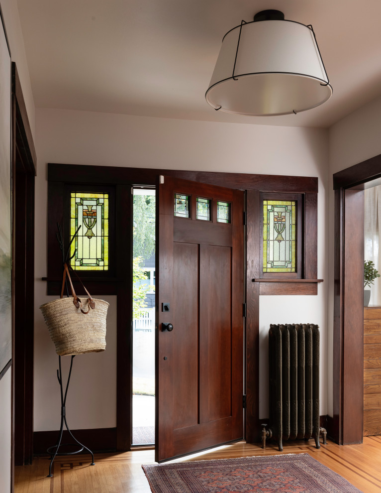 Single front door - craftsman medium tone wood floor and black floor single front door idea in Seattle with white walls and a dark wood front door