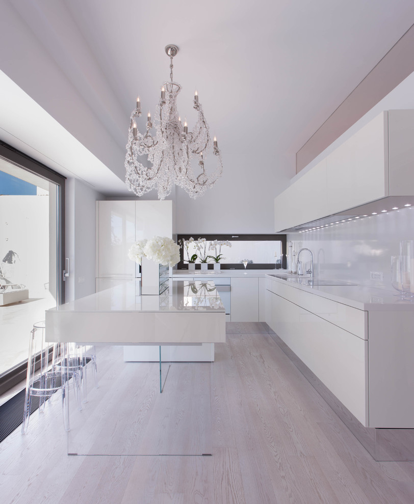 Design ideas for a mid-sized contemporary kitchen in Other with flat-panel cabinets, white cabinets, white splashback, light hardwood floors and with island.
