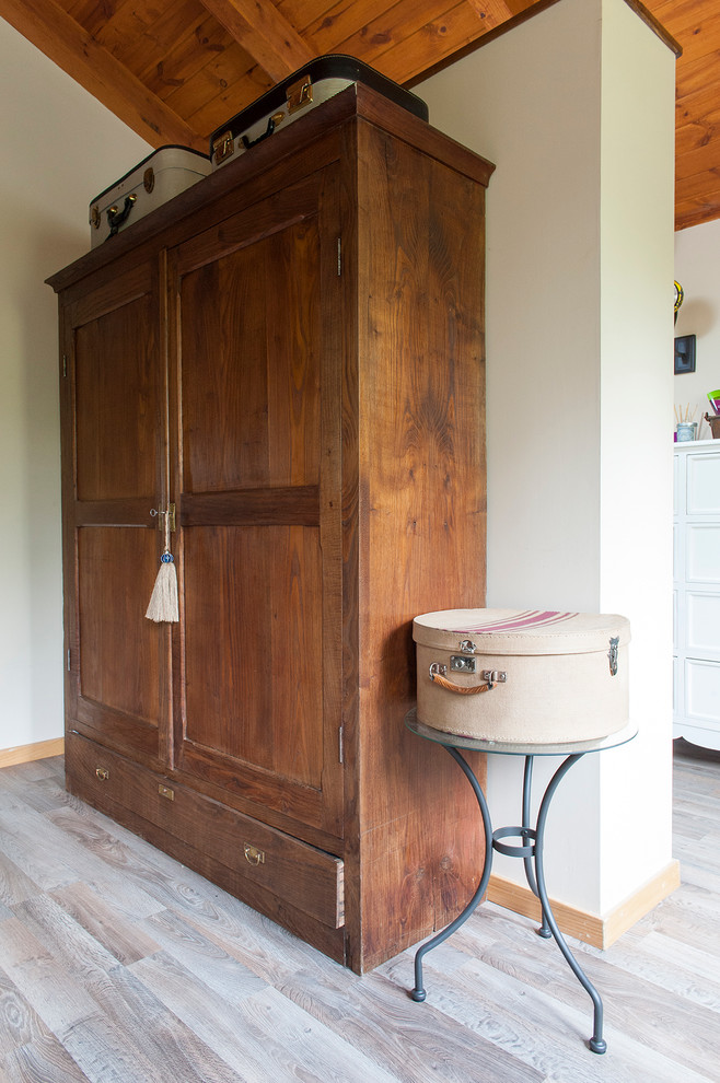 Small midcentury gender-neutral built-in wardrobe in Other with dark wood cabinets.