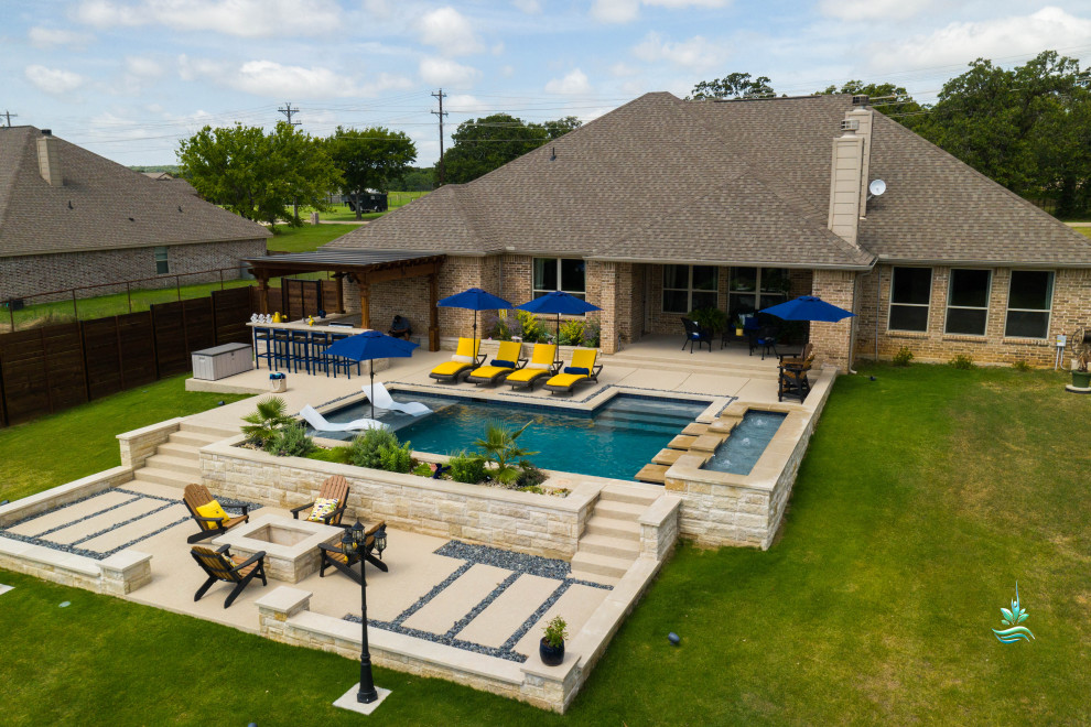Photo of an expansive mediterranean backyard custom-shaped infinity pool in Dallas with with a pool and decking.