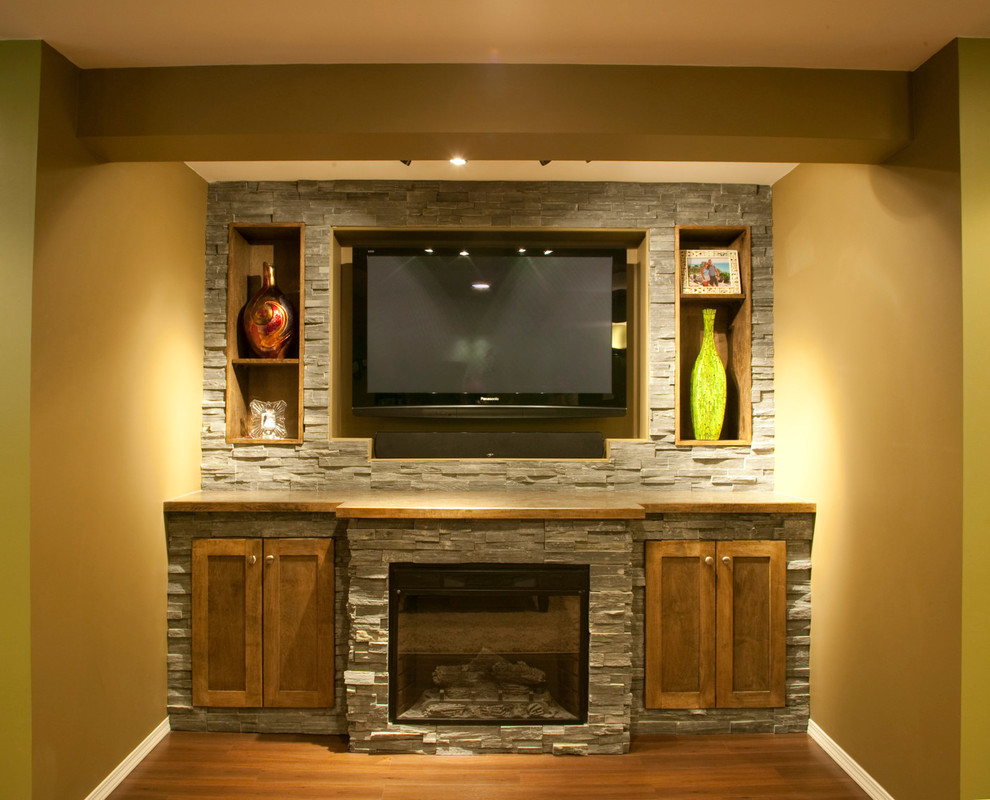 This is an example of a large contemporary look-out basement in Other with green walls, dark hardwood floors, a standard fireplace and a stone fireplace surround.