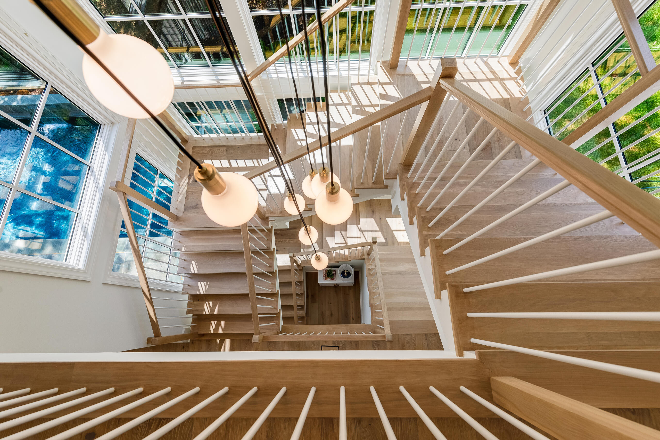 Project #152 | Three-Story White Oak Staircase with a Pendant Chandelier