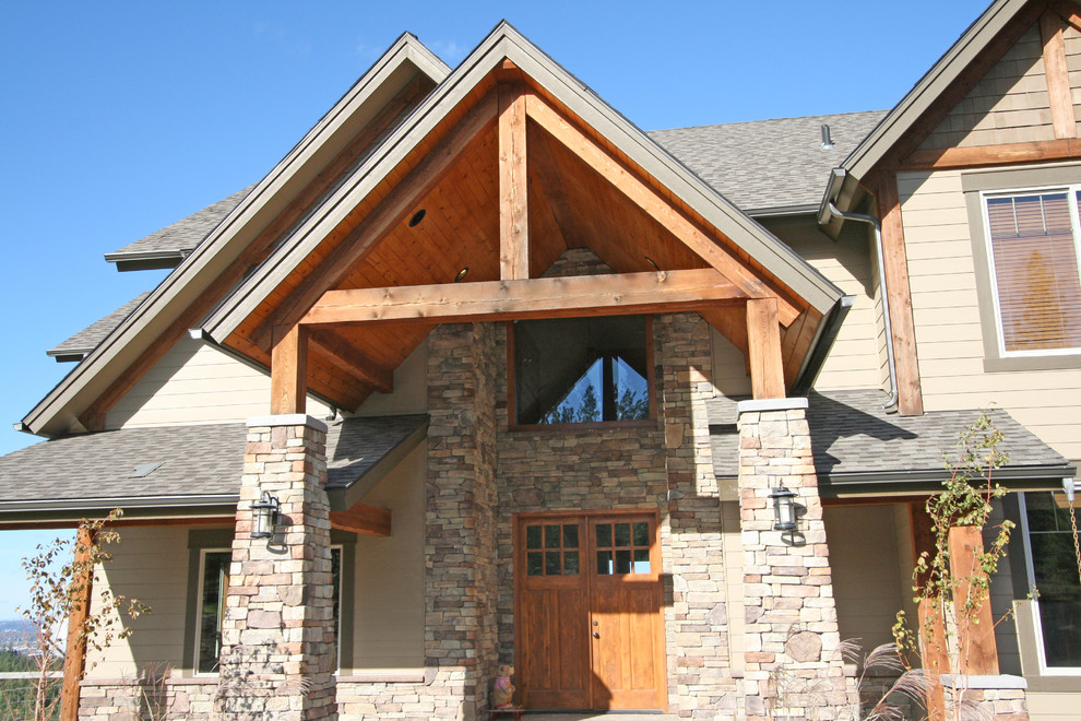 Example of a large mountain style brown two-story mixed siding gable roof design in Seattle