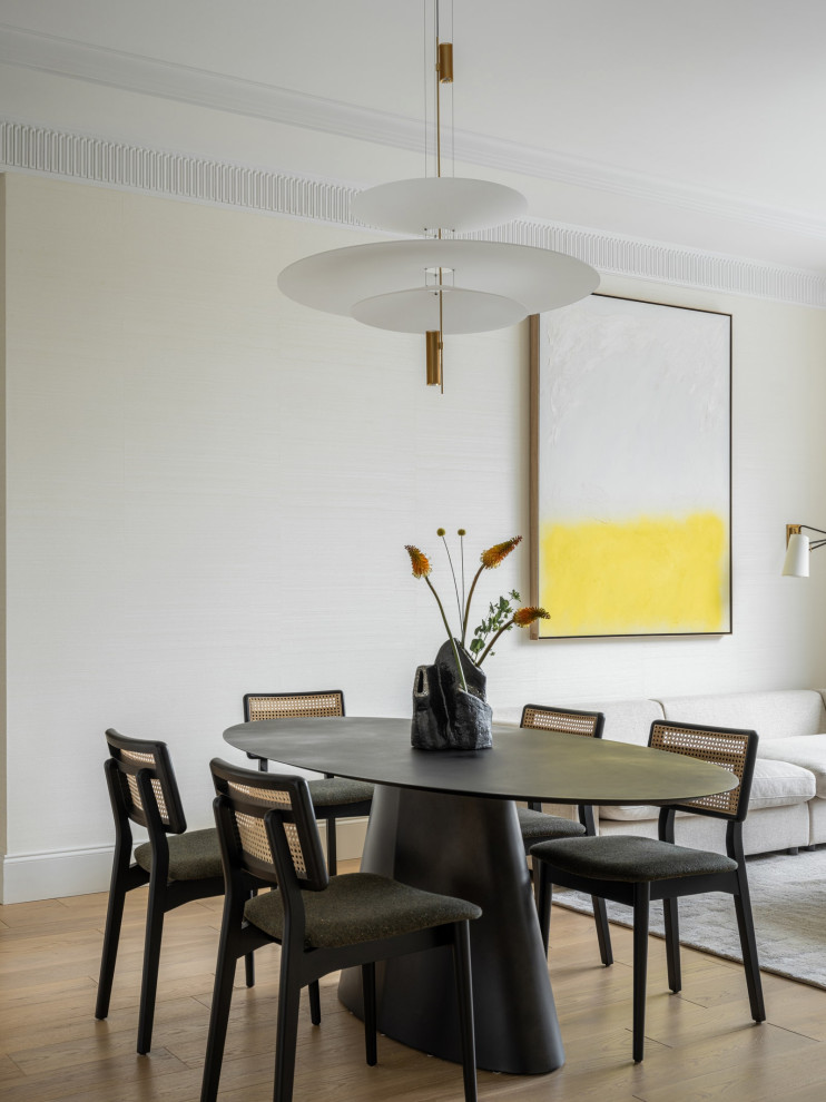 This is an example of a medium sized contemporary dining room in New York with beige walls and beige floors.