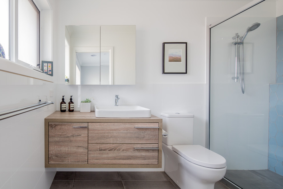 Photo of a small traditional master bathroom in Canberra - Queanbeyan with furniture-like cabinets, light wood cabinets, an alcove shower, a one-piece toilet, white tile, ceramic tile, white walls, ceramic floors, a drop-in sink, laminate benchtops, beige floor, an open shower and brown benchtops.