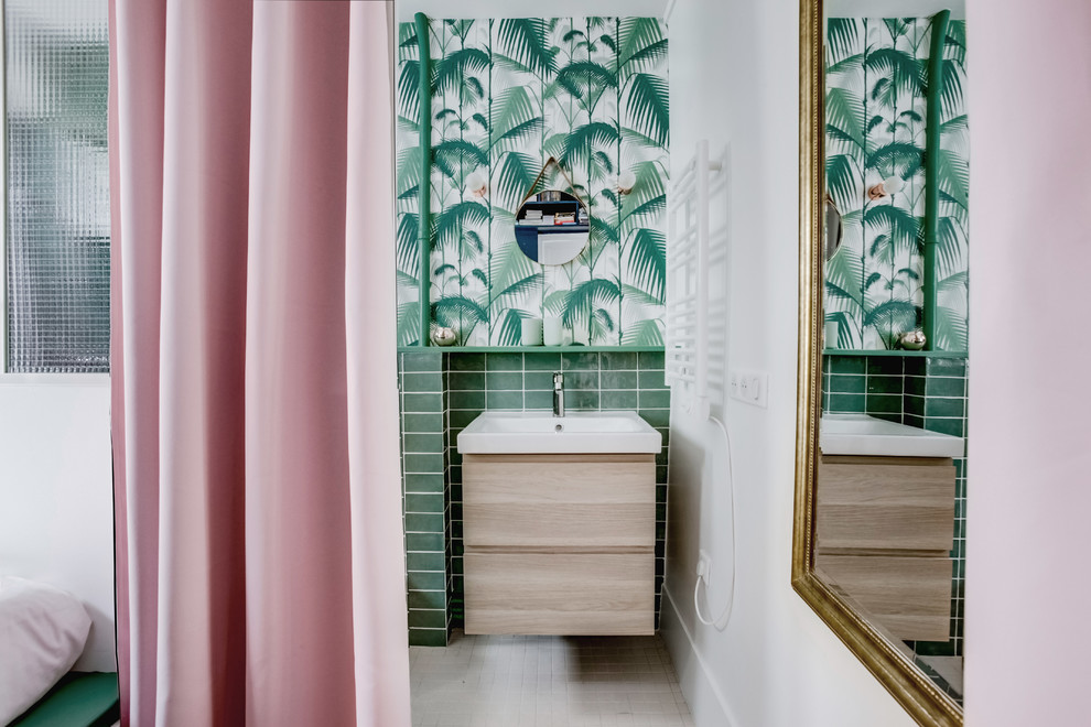 Photo of a contemporary bathroom in Paris with flat-panel cabinets, light wood cabinets, green tile, white walls, mosaic tile floors, a console sink and white floor.