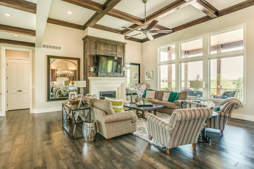 Large transitional formal open concept living room in Wichita with white walls, dark hardwood floors, a standard fireplace, a wood fireplace surround and a wall-mounted tv.