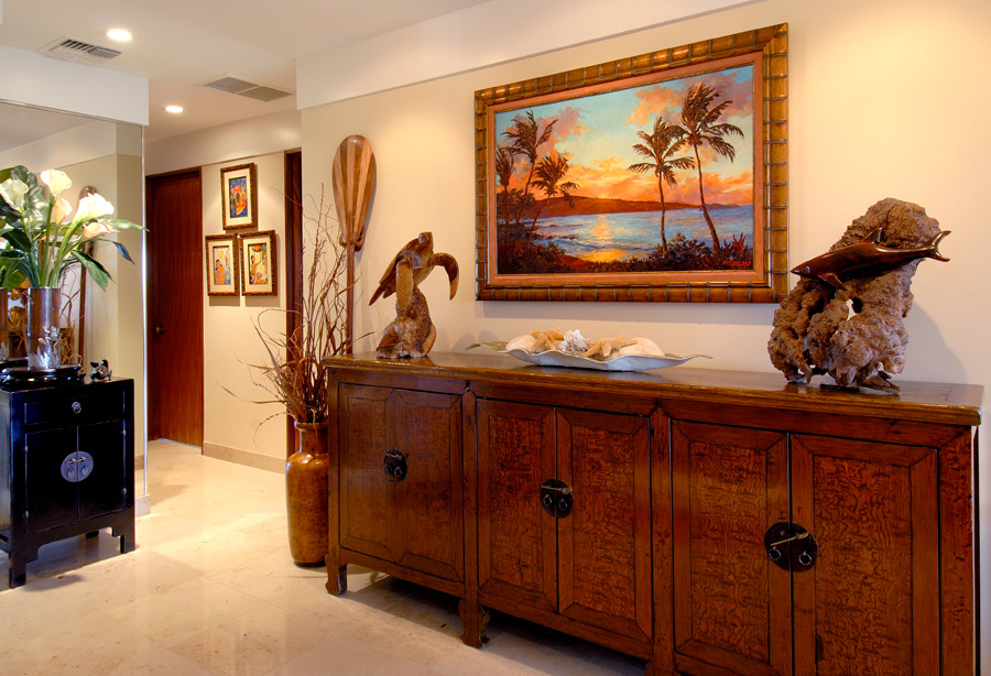 Design ideas for a mid-sized tropical foyer in Hawaii with beige walls and marble floors.