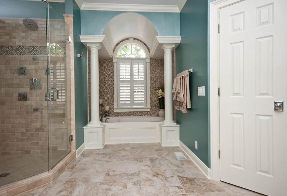Example of a mid-sized transitional master drop-in bathtub design with blue walls and a hinged shower door